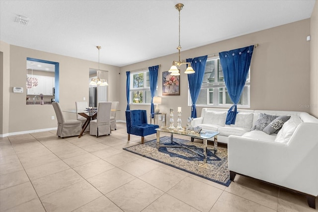 living room featuring a notable chandelier and tile patterned floors