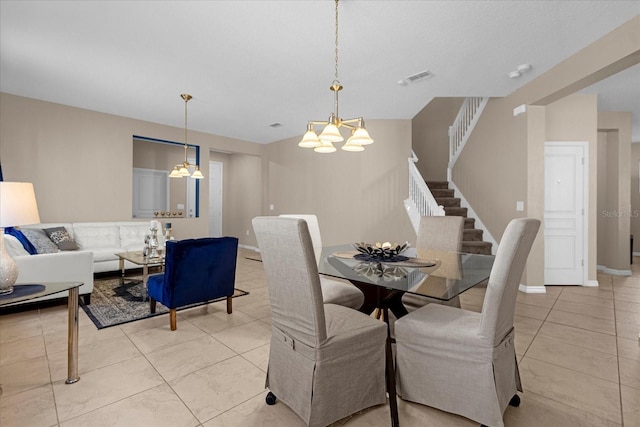 tiled dining area featuring a chandelier