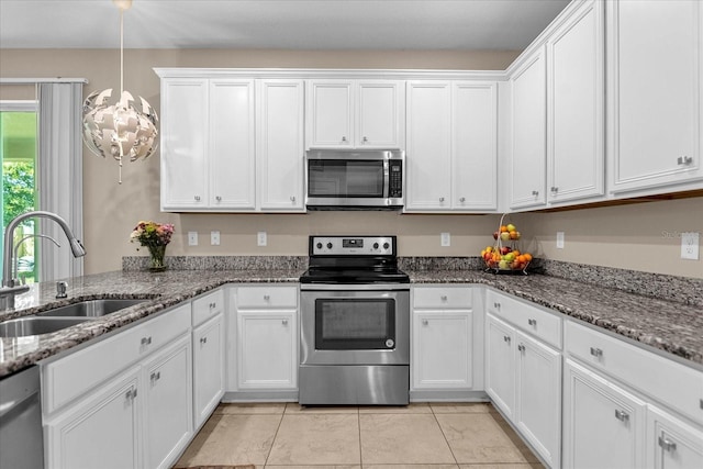 kitchen with stainless steel appliances, light tile patterned floors, stone countertops, white cabinets, and sink