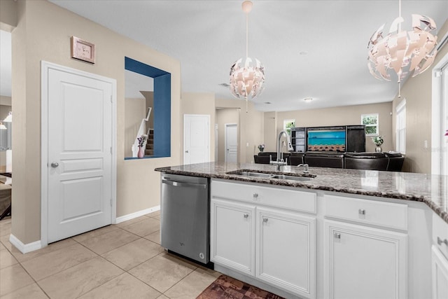 kitchen featuring white cabinets, pendant lighting, dishwasher, and an inviting chandelier