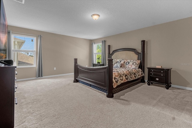 bedroom featuring a textured ceiling and light carpet