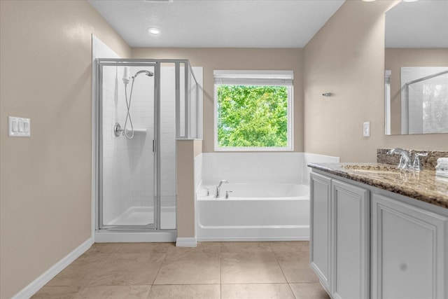 bathroom featuring shower with separate bathtub, tile patterned floors, and vanity