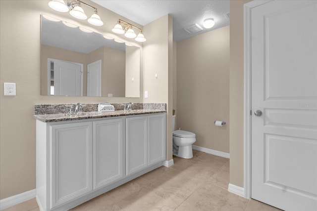 bathroom featuring toilet, tile patterned flooring, a textured ceiling, and vanity