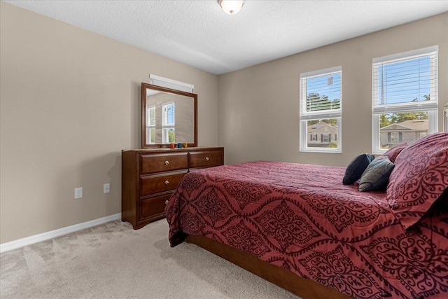 carpeted bedroom with a textured ceiling