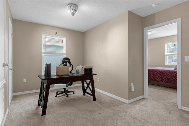 carpeted office space featuring plenty of natural light