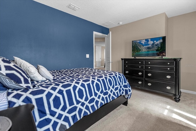 bedroom with a textured ceiling and carpet