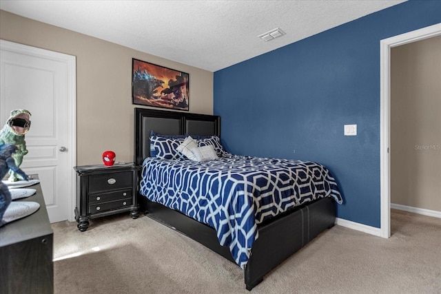 bedroom featuring a textured ceiling and carpet floors