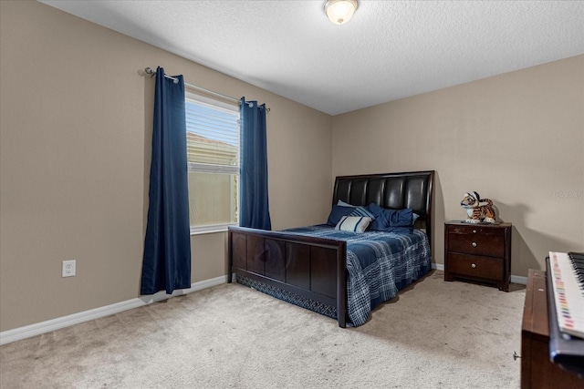 bedroom featuring a textured ceiling and light carpet