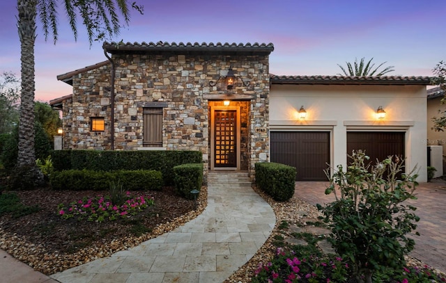 mediterranean / spanish-style house with a garage