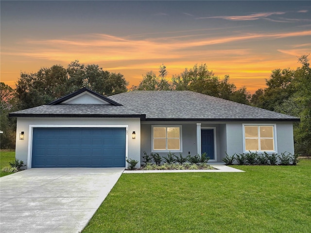 ranch-style home with a yard and a garage