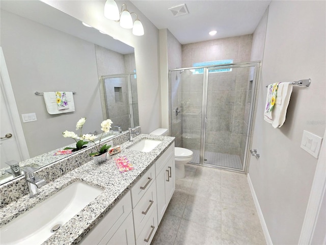 bathroom featuring a shower with door, vanity, and toilet