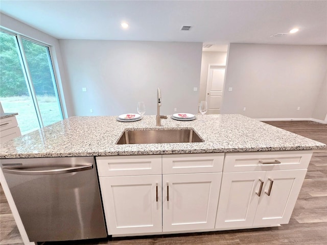 kitchen featuring light stone counters, stainless steel dishwasher, light hardwood / wood-style flooring, white cabinets, and sink