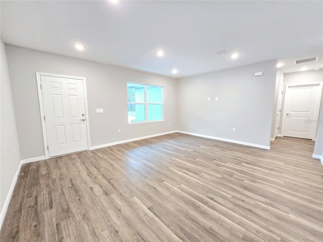 unfurnished room with light wood-type flooring