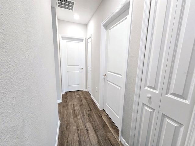 corridor with dark hardwood / wood-style floors