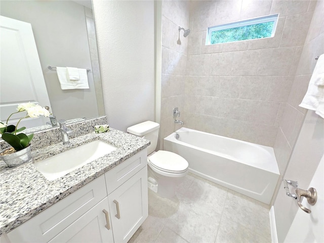 full bathroom with toilet, vanity, and tiled shower / bath