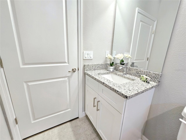 bathroom with tile patterned floors and vanity