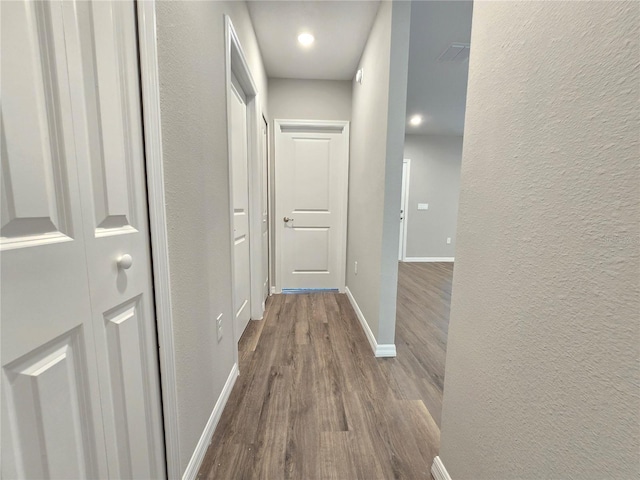 hallway with hardwood / wood-style floors