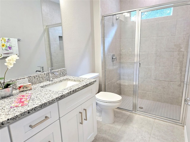 bathroom featuring toilet, walk in shower, and vanity