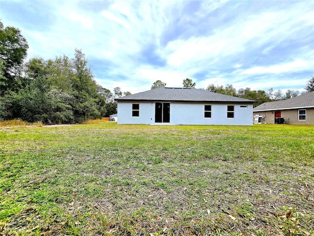 back of property featuring a lawn