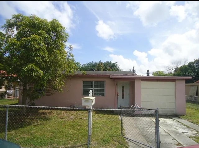 view of front of house with a front yard and a garage