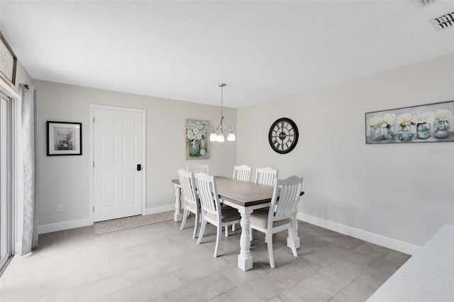 dining space with a notable chandelier