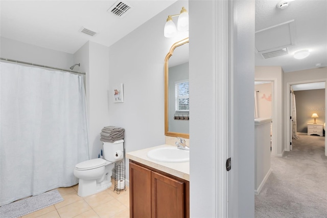 bathroom featuring vanity, tile patterned floors, and toilet