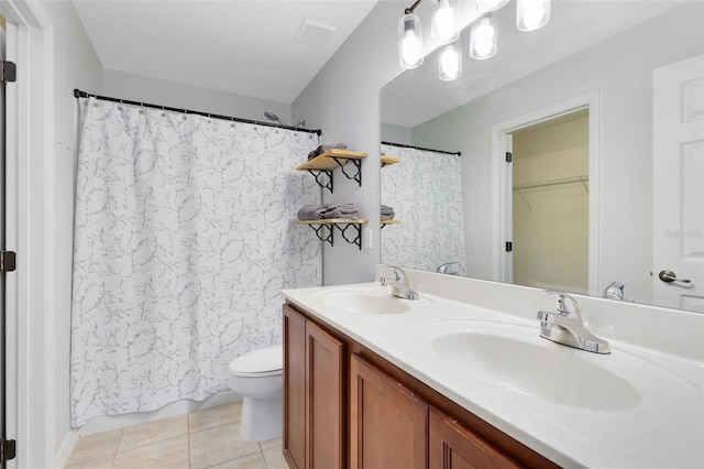 bathroom featuring vanity, tile patterned floors, and toilet