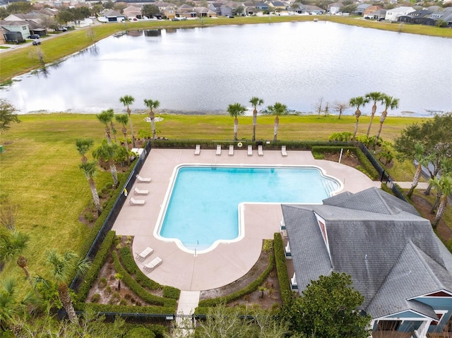 view of pool featuring a water view and a patio