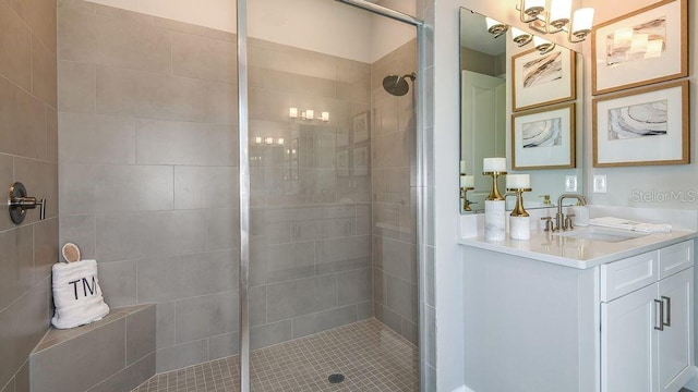 bathroom featuring walk in shower and vanity