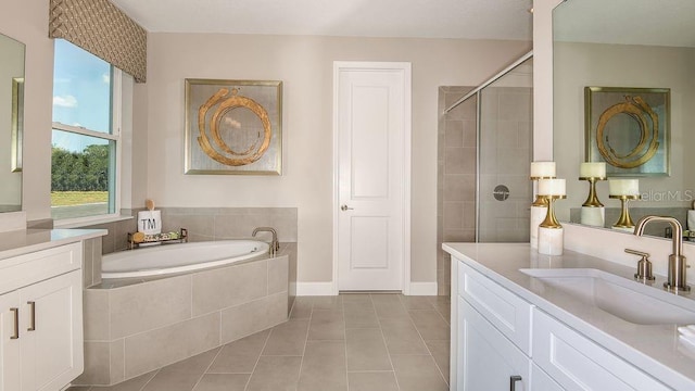 bathroom with vanity, a wealth of natural light, and tile patterned floors