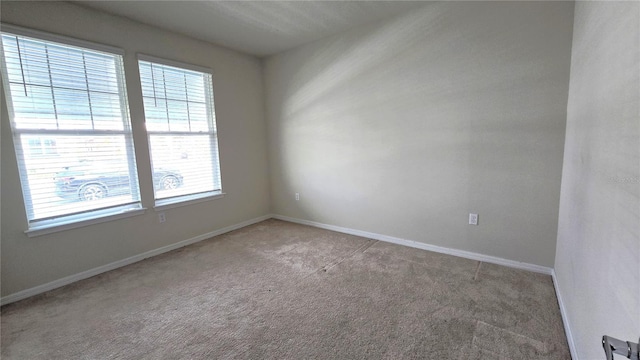 carpeted empty room with plenty of natural light