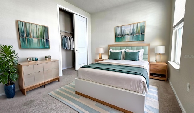 carpeted bedroom featuring a closet and multiple windows