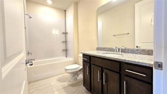 full bathroom featuring toilet, vanity, tile patterned flooring, and shower / tub combination