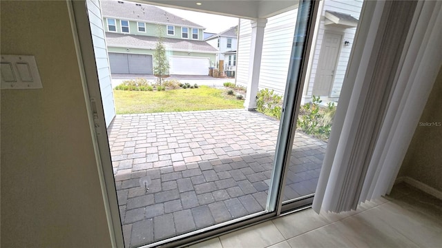 doorway with light tile patterned floors