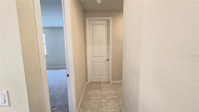 hallway featuring light tile patterned floors