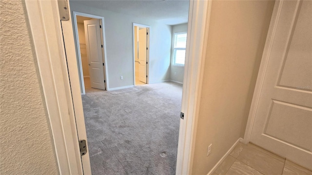 corridor with light colored carpet