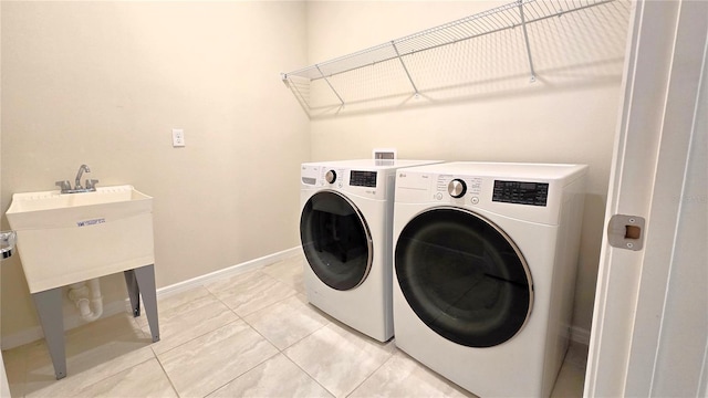 washroom with light tile patterned floors and separate washer and dryer