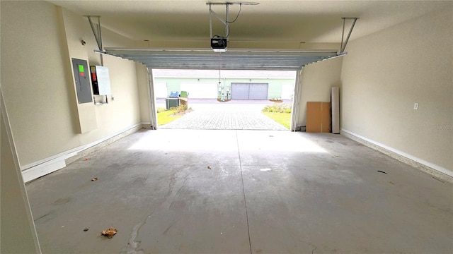 garage featuring electric panel and a garage door opener