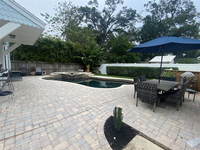 view of swimming pool with a patio and an in ground hot tub