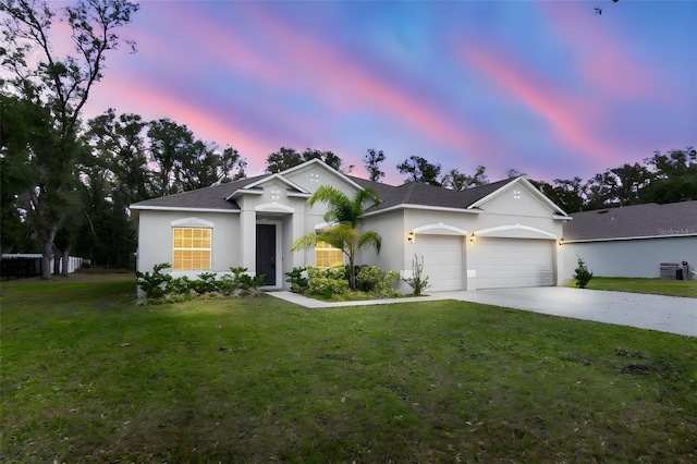 view of front facade with a garage and a lawn