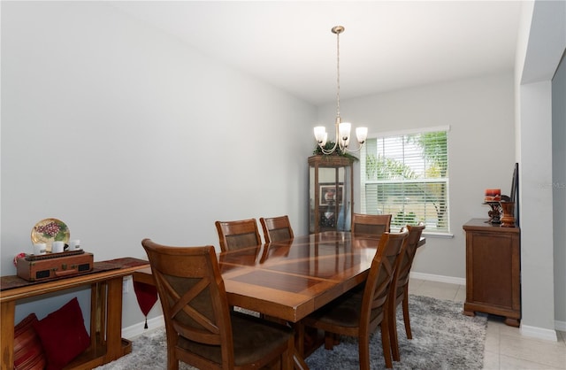 dining space featuring light tile patterned floors and an inviting chandelier