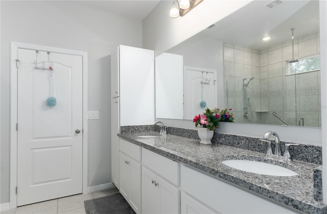 bathroom featuring vanity, tile patterned flooring, and a shower with door