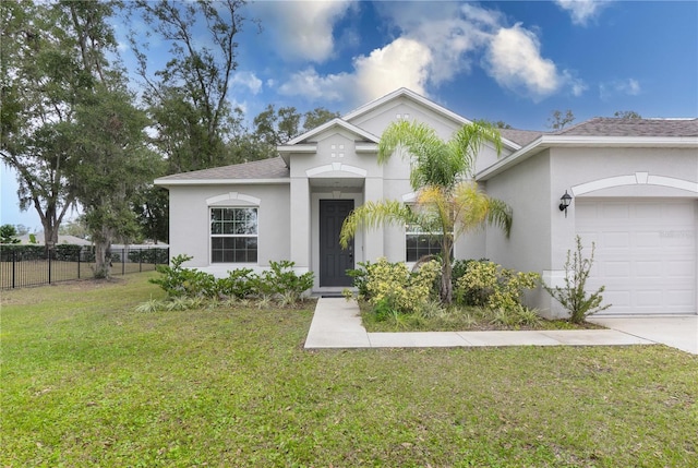 view of front of home featuring a front yard and a garage