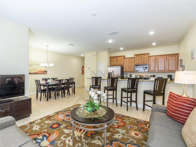 living room featuring light tile patterned floors and a notable chandelier