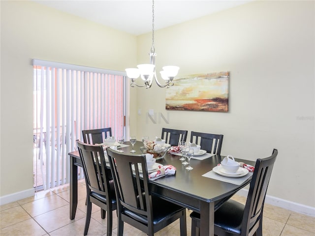 tiled dining space featuring an inviting chandelier