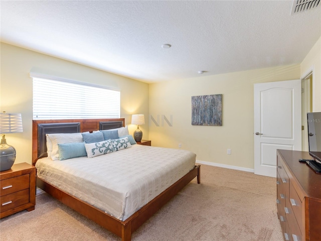 carpeted bedroom featuring a textured ceiling