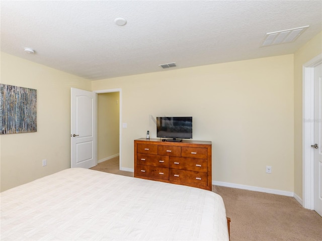 carpeted bedroom featuring a textured ceiling