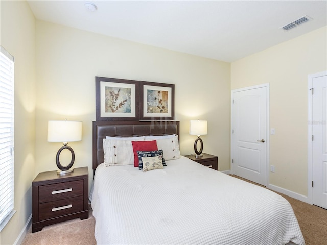 carpeted bedroom featuring multiple windows