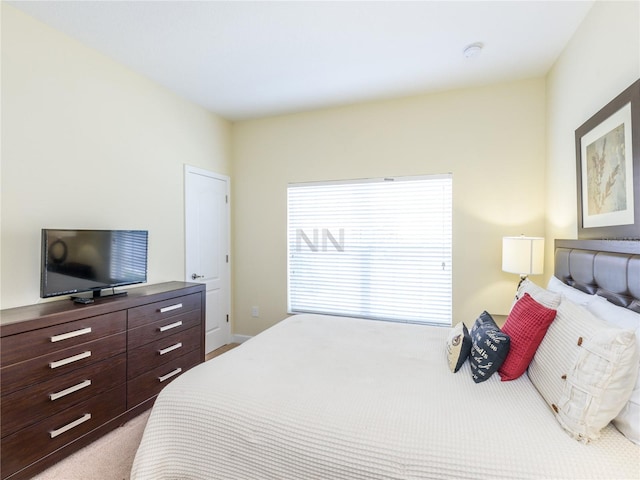 bedroom featuring light colored carpet