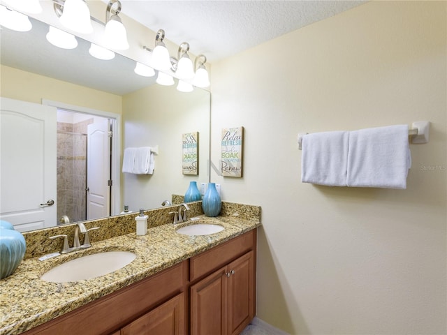 bathroom with vanity and a textured ceiling